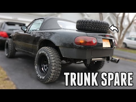 How to put a spare tire back in the trunk